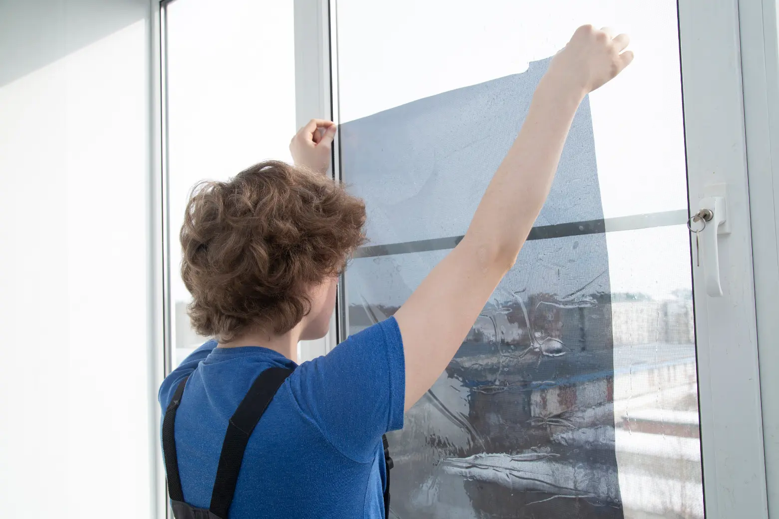 Security window film reinforcing glass against impact and forced entry